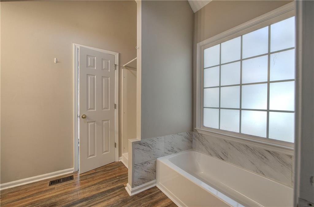 15 Roving Hills Circle Cartersville, GA 30121 - Photo 23 of 55 a bathroom with a bathtub and window