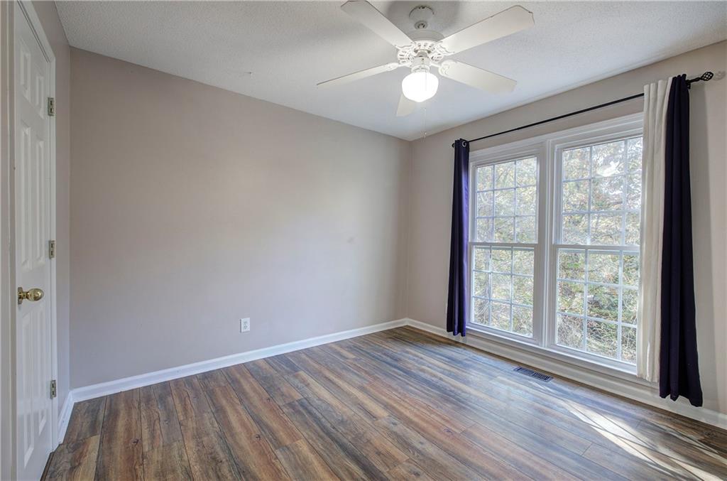 15 Roving Hills Circle Cartersville, GA 30121 - Photo 27 of 55 wooden floor in an empty room with a window