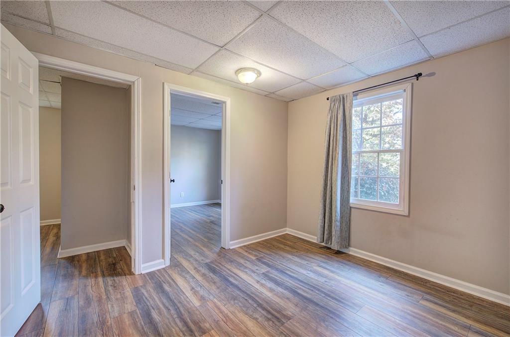 15 Roving Hills Circle Cartersville, GA 30121 - Photo 35 of 55 an empty room with wooden floor and windows