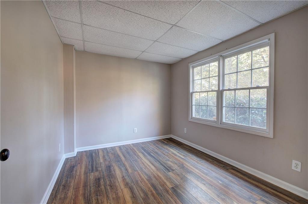 15 Roving Hills Circle Cartersville, GA 30121 - Photo 37 of 55 an empty room with wooden floor and windows