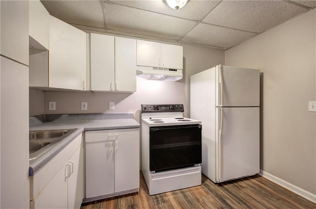 15 Roving Hills Circle Cartersville, GA 30121 - Photo 41 of 55 a kitchen with a refrigerator sink and cabinets