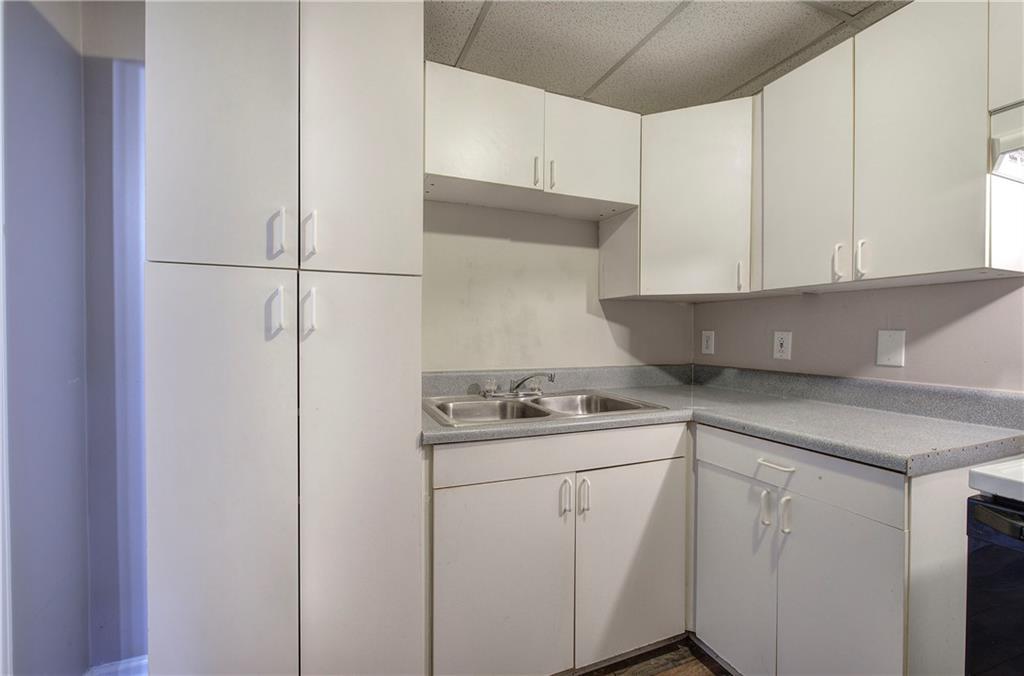 15 Roving Hills Circle Cartersville, GA 30121 - Photo 42 of 55 a kitchen with a sink and cabinets