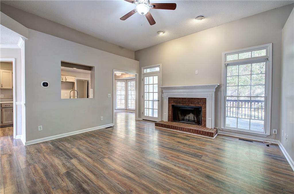 15 Roving Hills Circle Cartersville, GA 30121 - Photo 6 of 55 an empty room with wooden floor fireplace and windows
