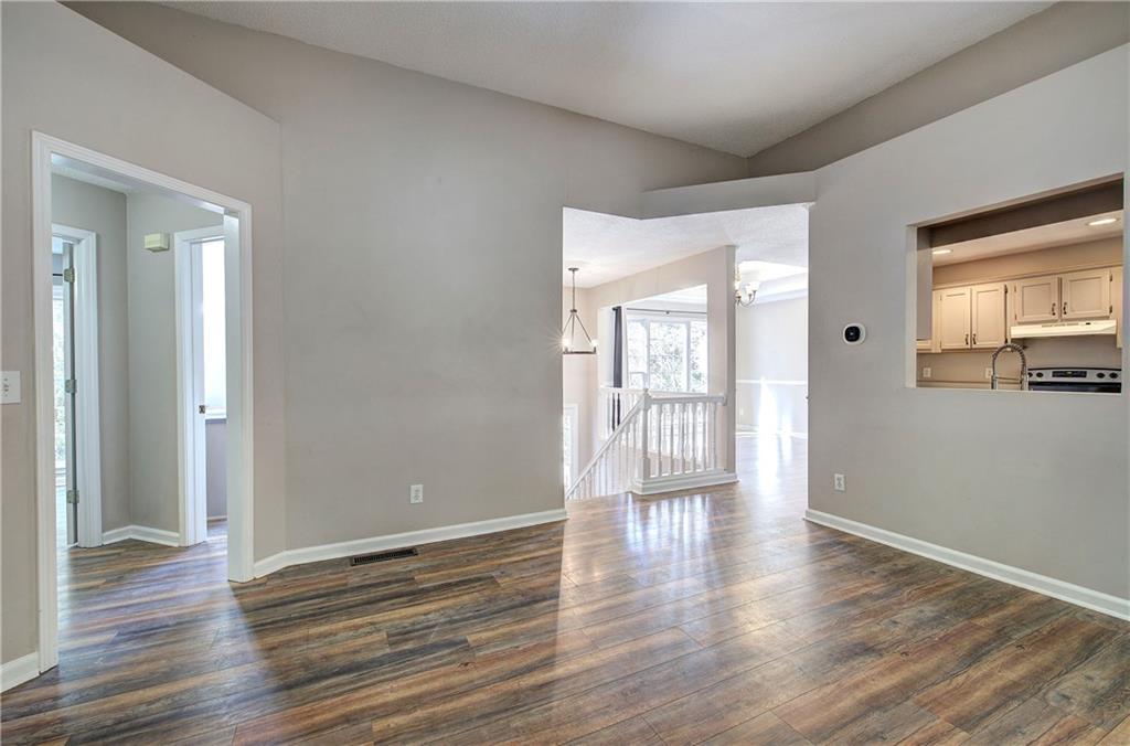 15 Roving Hills Circle Cartersville, GA 30121 - Photo 7 of 55 a view of an empty room with wooden floor and a window
