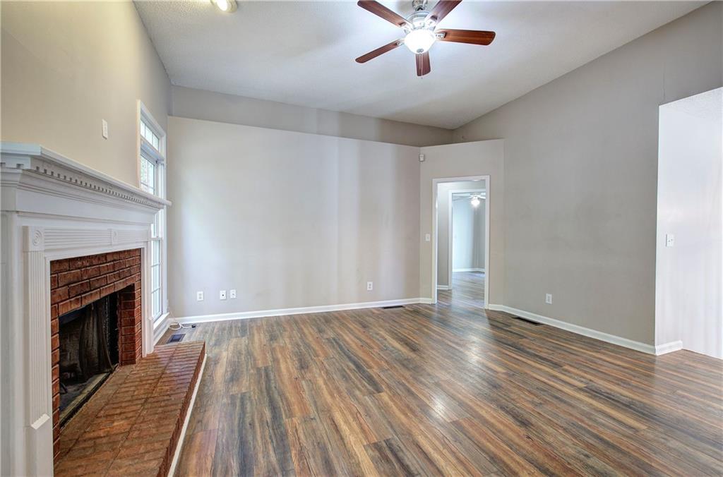 15 Roving Hills Circle Cartersville, GA 30121 - Photo 9 of 55 a view of an empty room with wooden floor and a fireplace