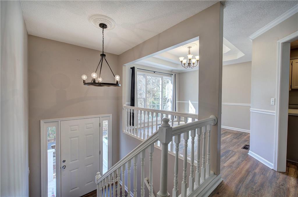 15 Roving Hills Circle Cartersville, GA 30121 - Photo 10 of 55 a view of a hallway view with wooden floor and staircase