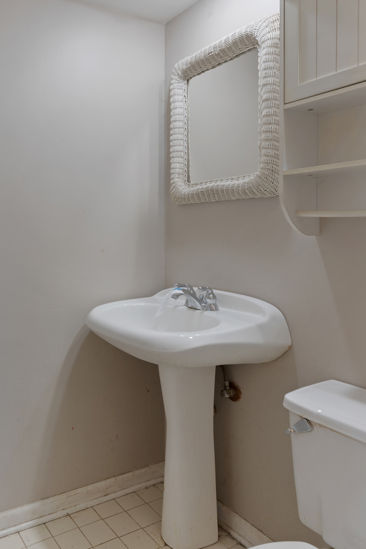 1950 Ashley Road Hoffman Estates, IL 60169 - Photo 16 of 19 a bathroom with a sink a toilet and mirror