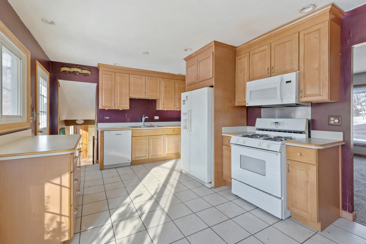 1950 Ashley Road Hoffman Estates, IL 60169 - Photo 5 of 19 a kitchen with a stove a sink and a refrigerator