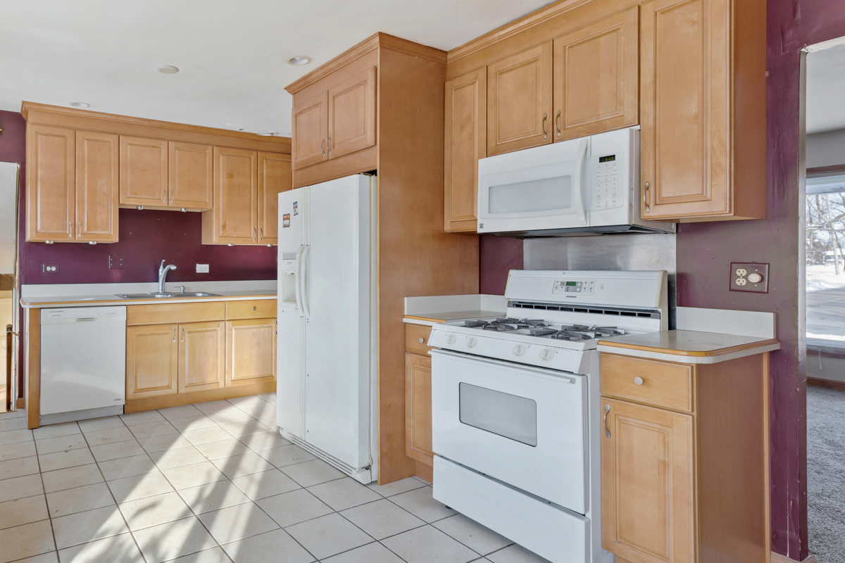 1950 Ashley Road Hoffman Estates, IL 60169 - Photo 6 of 19 a kitchen with a stove sink and cabinets