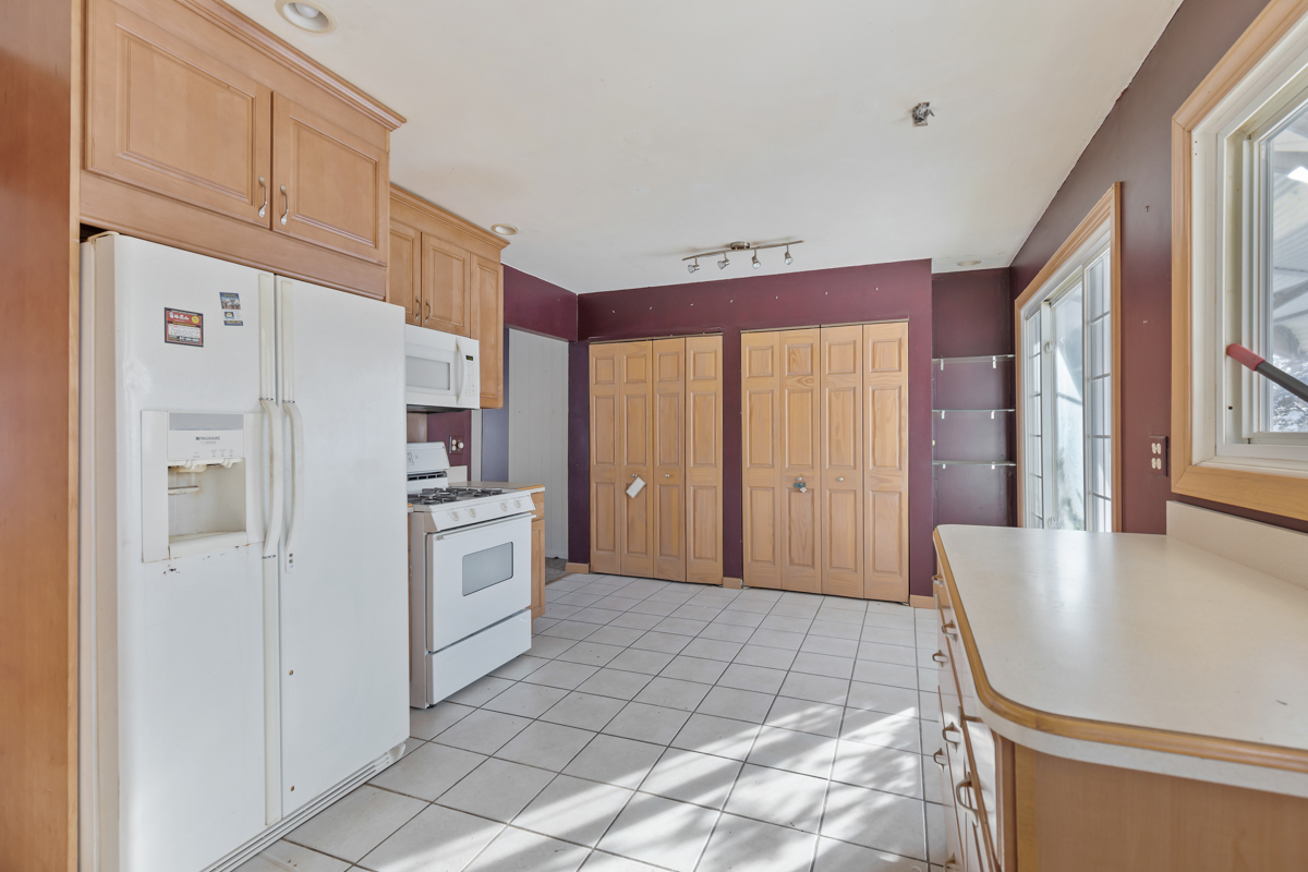 1950 Ashley Road Hoffman Estates, IL 60169 - Photo 7 of 19 a kitchen with white cabinets and white appliances