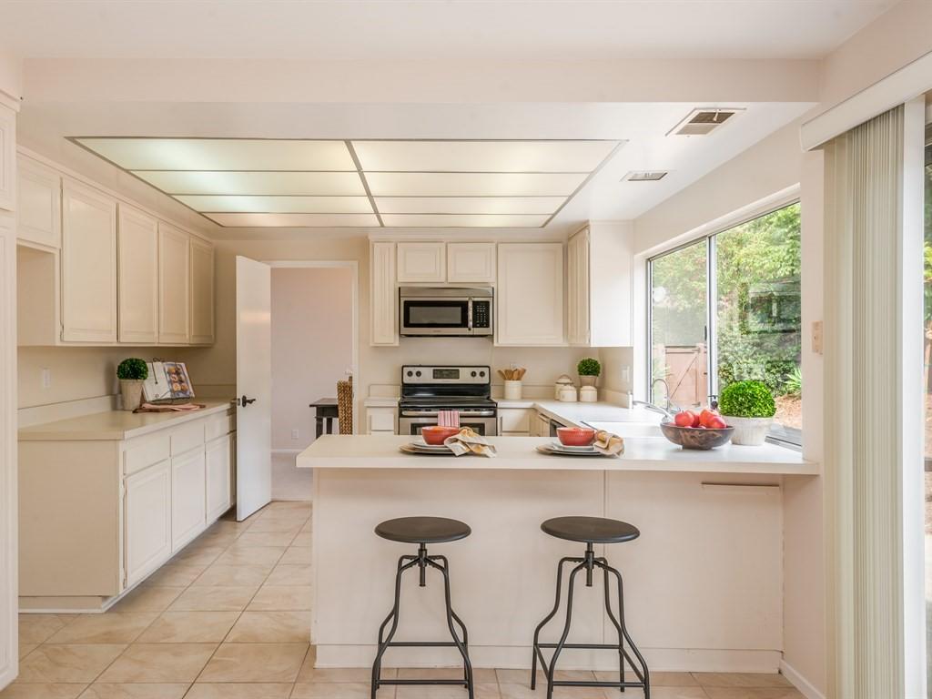 7166 Armstrong Road Goleta, CA 93117 - Photo 11 of 24 a kitchen with stainless steel appliances kitchen island granite countertop a sink and cabinets