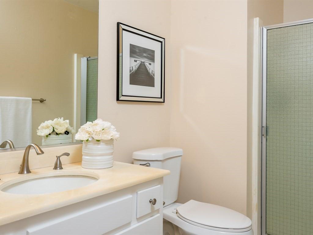7166 Armstrong Road Goleta, CA 93117 - Photo 13 of 24 a bathroom with a granite countertop toilet sink and mirror