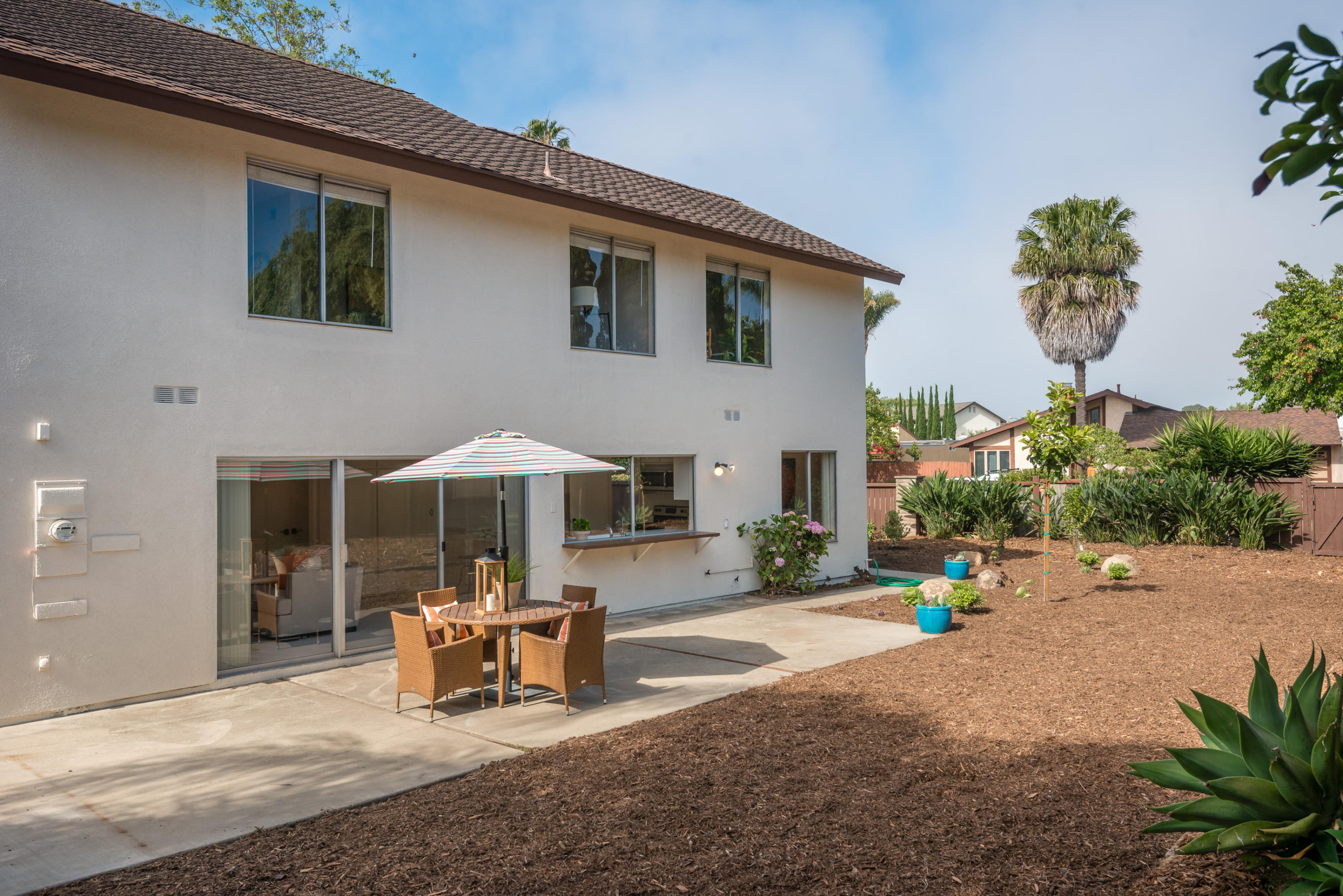 7166 Armstrong Road Goleta, CA 93117 - Photo 20 of 24 a backyard of a house with table and chairs