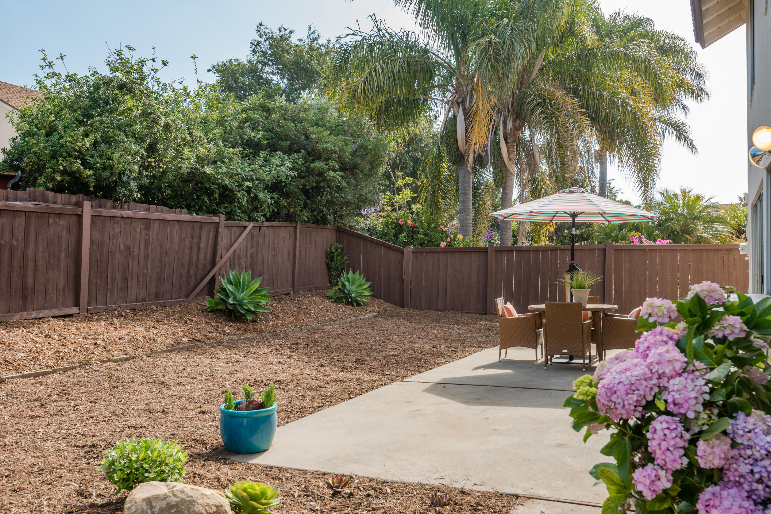 7166 Armstrong Road Goleta, CA 93117 - Photo 21 of 24 a backyard of a house with table and chairs