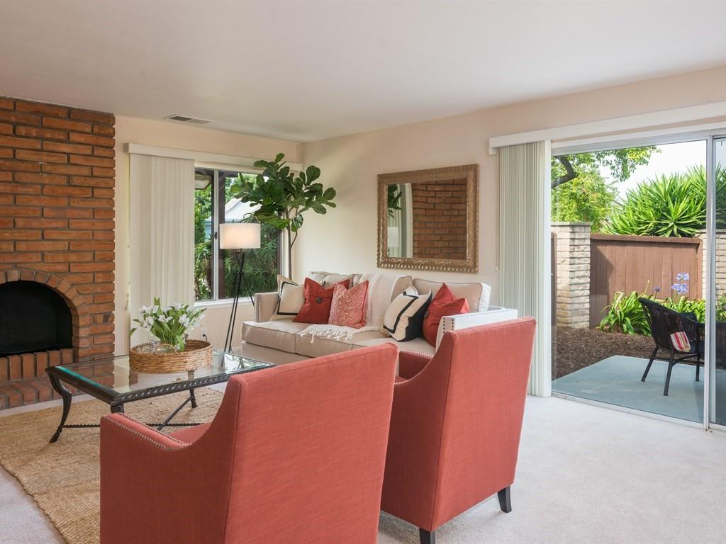 7166 Armstrong Road Goleta, CA 93117 - Photo 7 of 24 a living room with furniture a large window and a fireplace