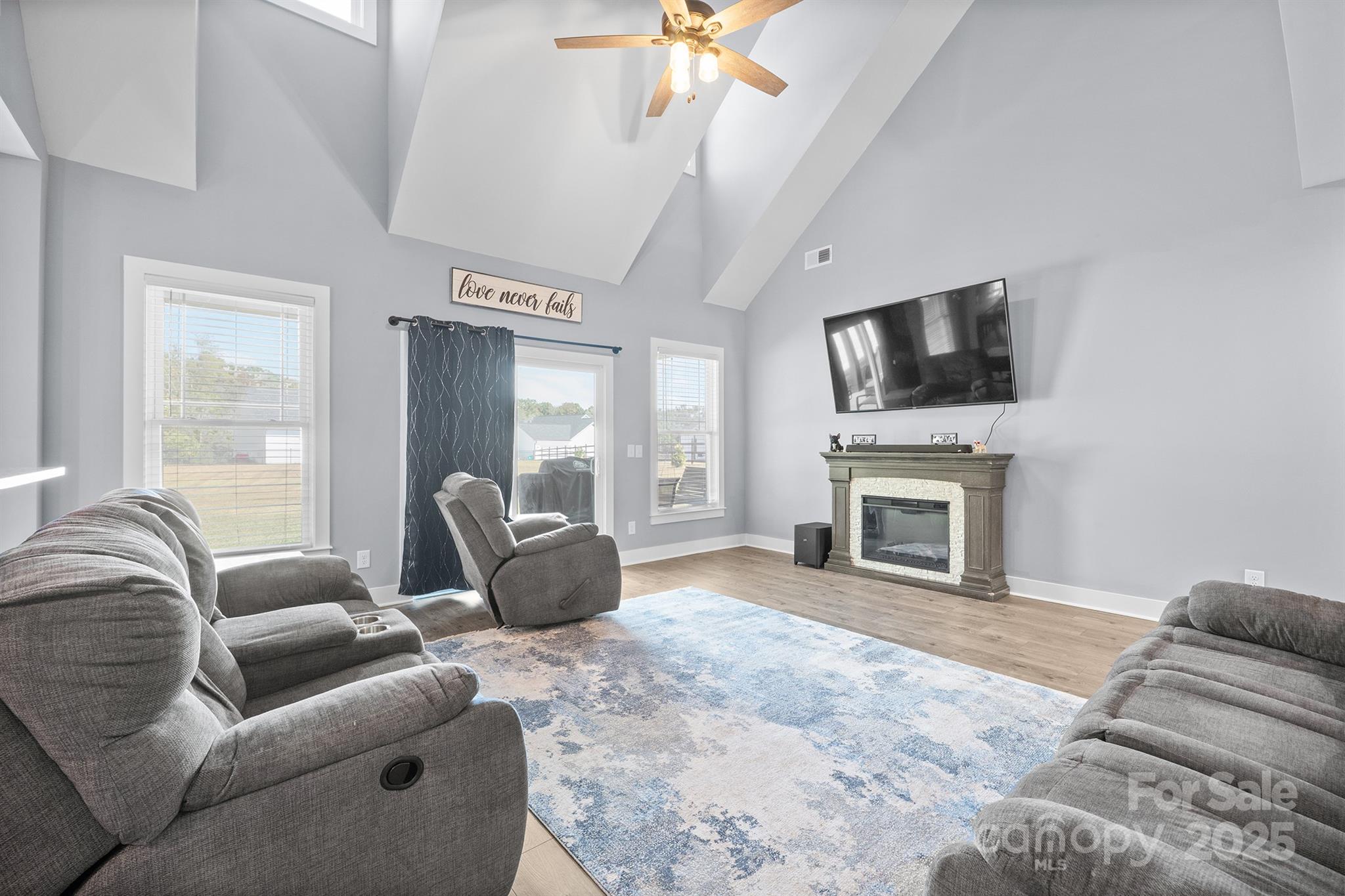 310 Stoneyard Road Richfield, NC 28137 - Photo 11 of 36 a living room with furniture a fireplace and a flat screen tv