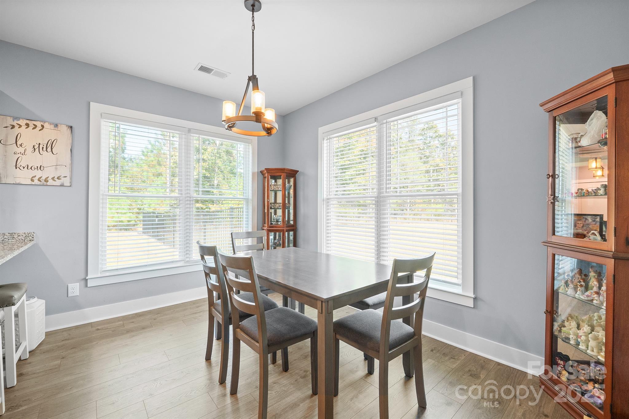 310 Stoneyard Road Richfield, NC 28137 - Photo 12 of 36 a dining room with furniture a chandelier and wooden floor