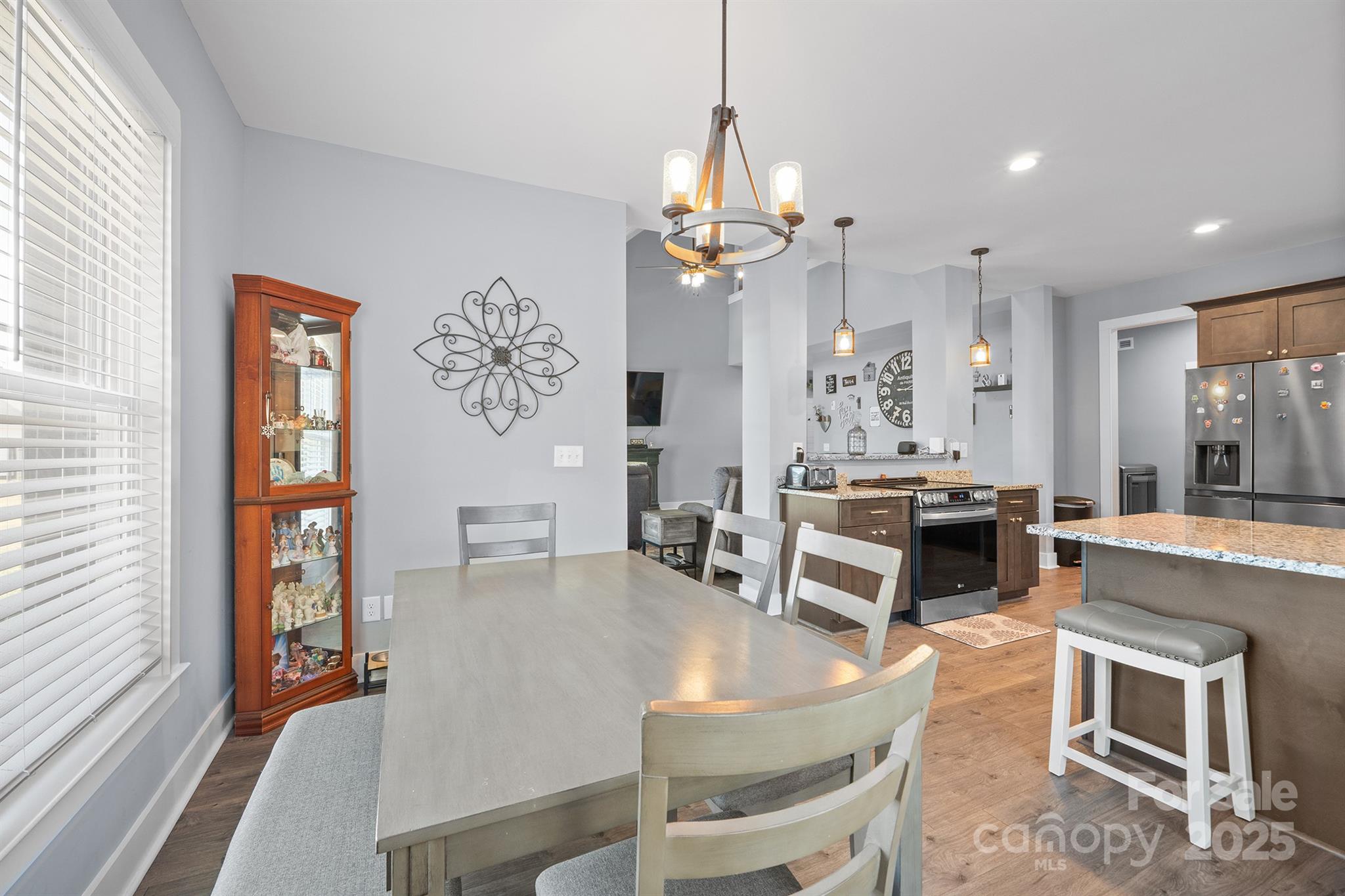 310 Stoneyard Road Richfield, NC 28137 - Photo 14 of 36 a dining room with wooden floor a chandelier a wooden table and chairs