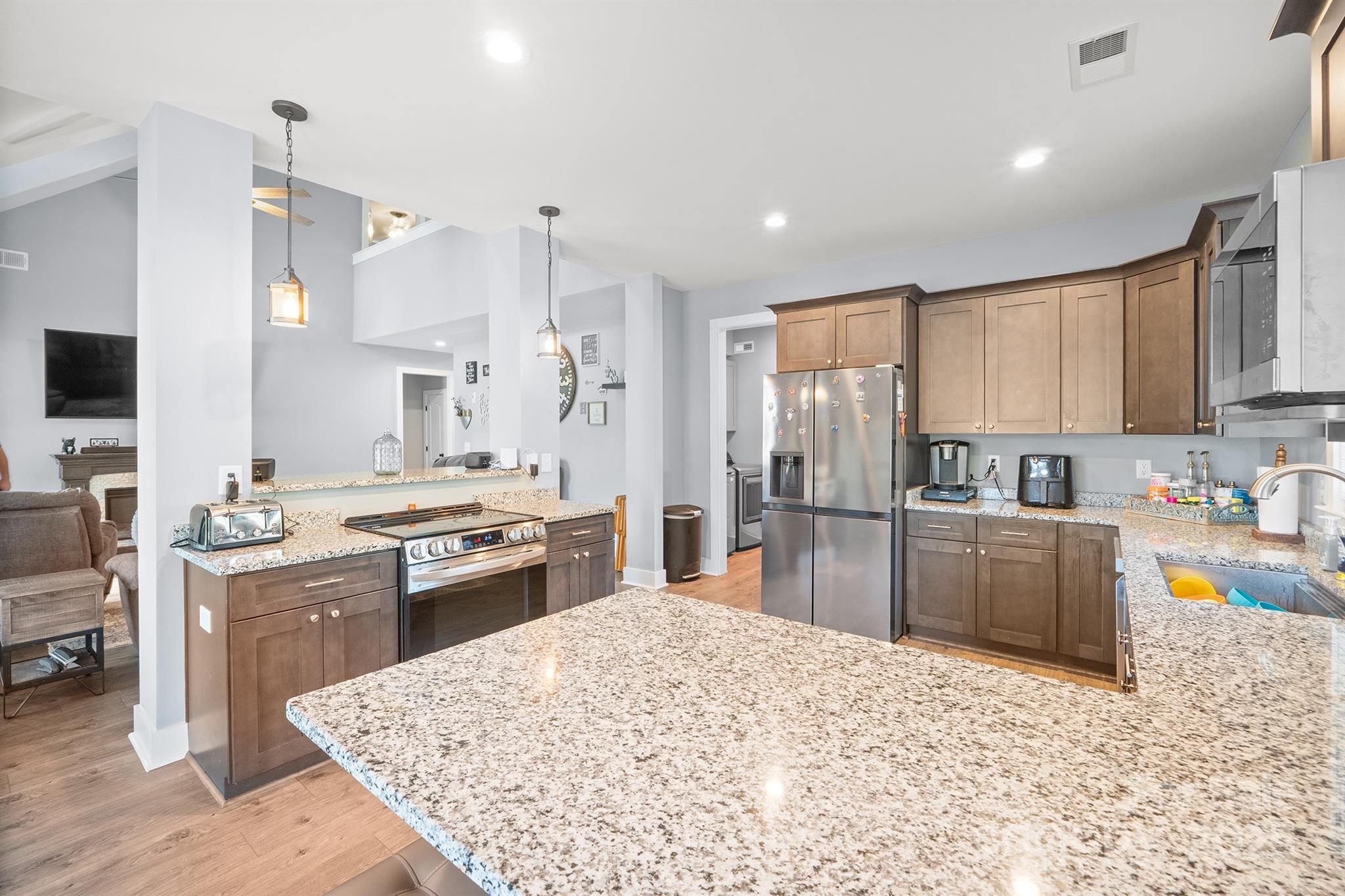 310 Stoneyard Road Richfield, NC 28137 - Photo 15 of 36 a large kitchen with kitchen island a sink stove and refrigerator