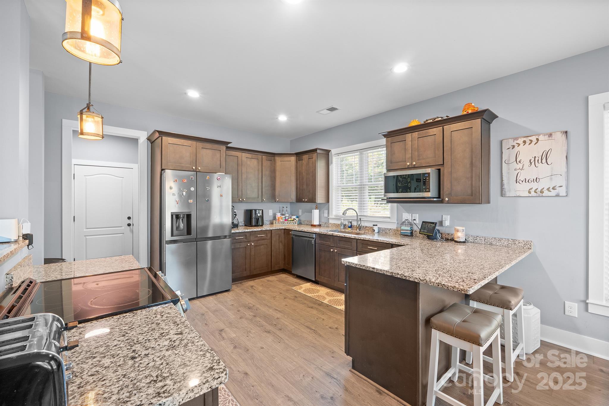 310 Stoneyard Road Richfield, NC 28137 - Photo 16 of 36 a kitchen with stainless steel appliances granite countertop a sink refrigerator and microwave