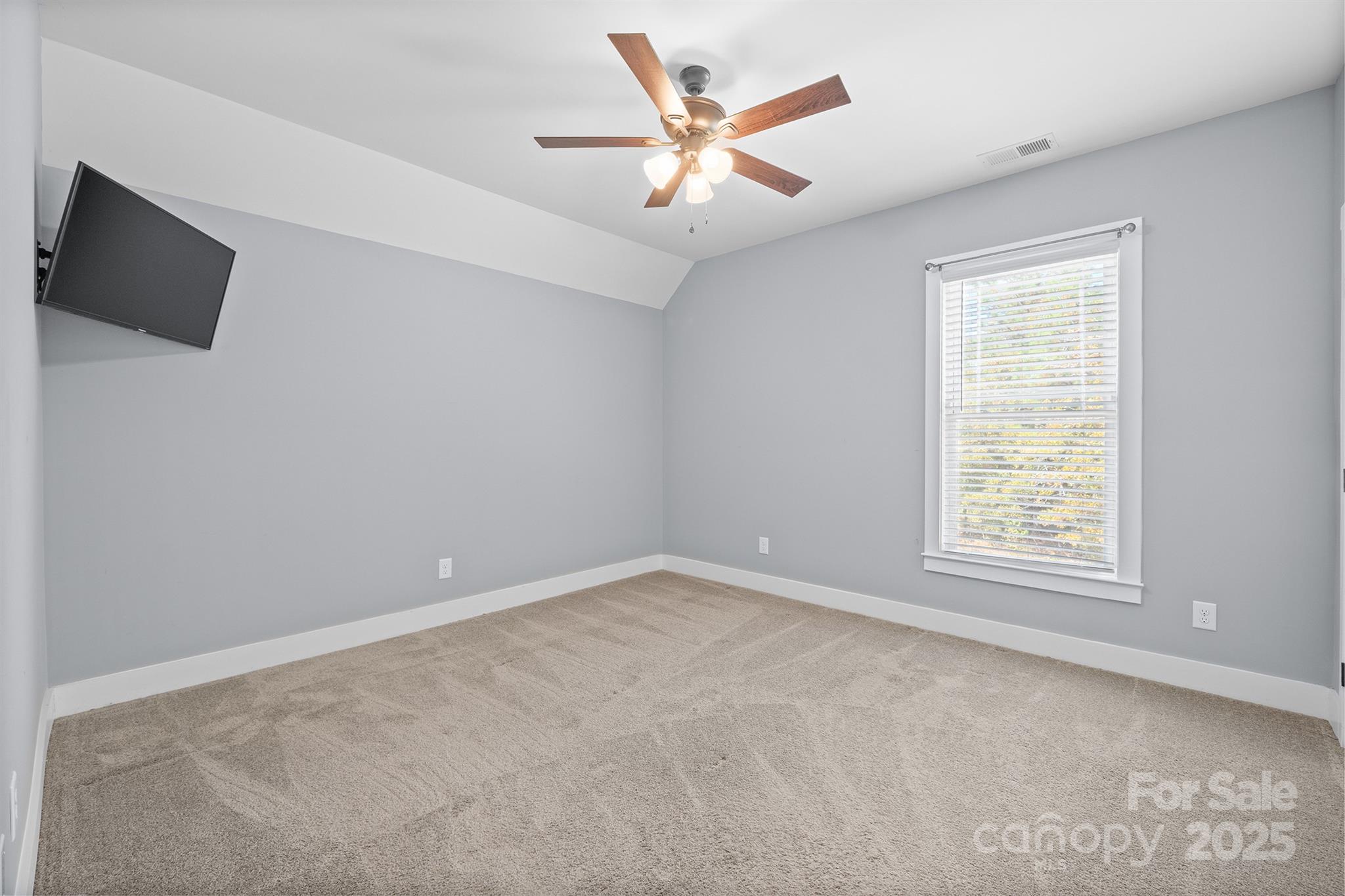 310 Stoneyard Road Richfield, NC 28137 - Photo 24 of 36 an empty room with windows and a ceiling fan