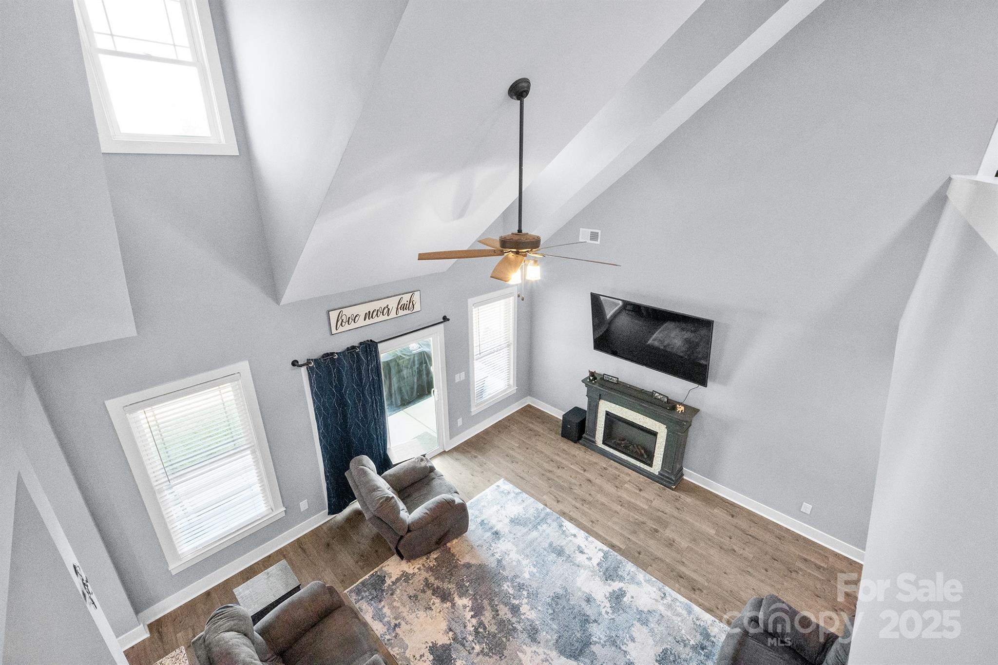 310 Stoneyard Road Richfield, NC 28137 - Photo 26 of 36 a view of a livingroom with a fireplace a window and a wooden floor