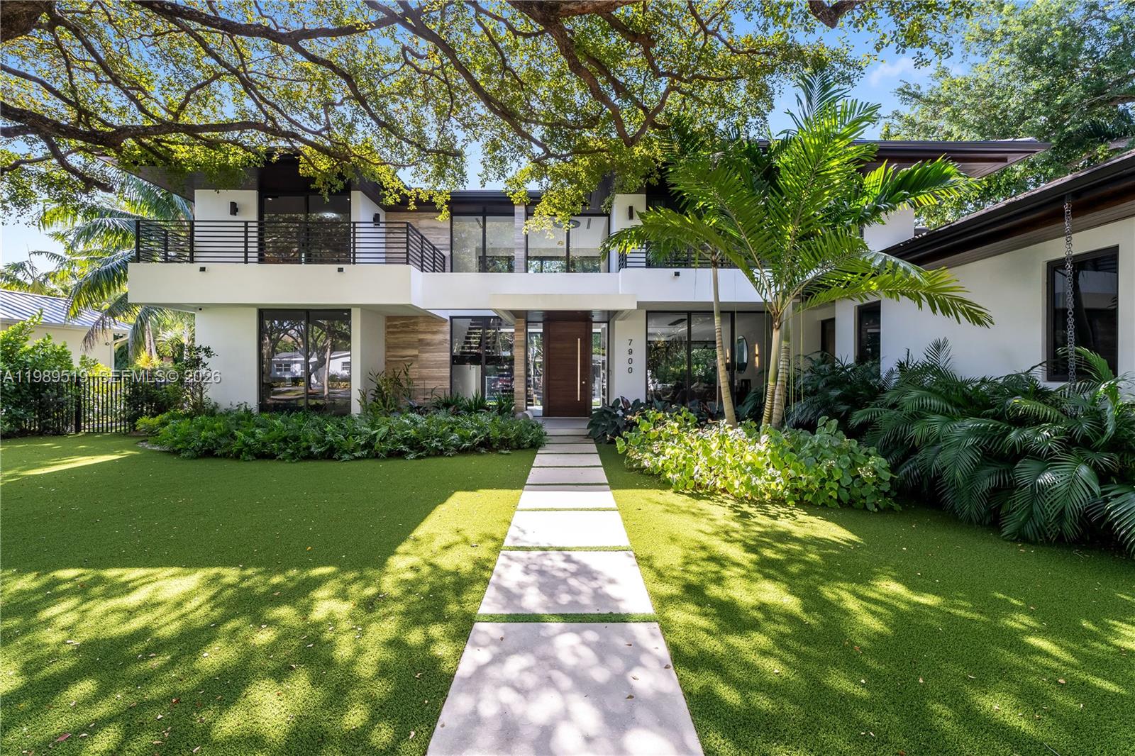7900 Southwest 57th Court South Miami, FL 33143 - Photo 1 of 55 a front view of a house with garden