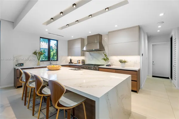 a large kitchen with a table and chairs