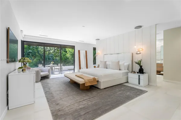 a bedroom with a large bed and a large window