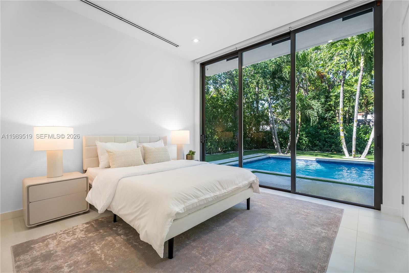 7900 Southwest 57th Court South Miami, FL 33143 - Photo 15 of 55 a bedroom with a bed and large windows