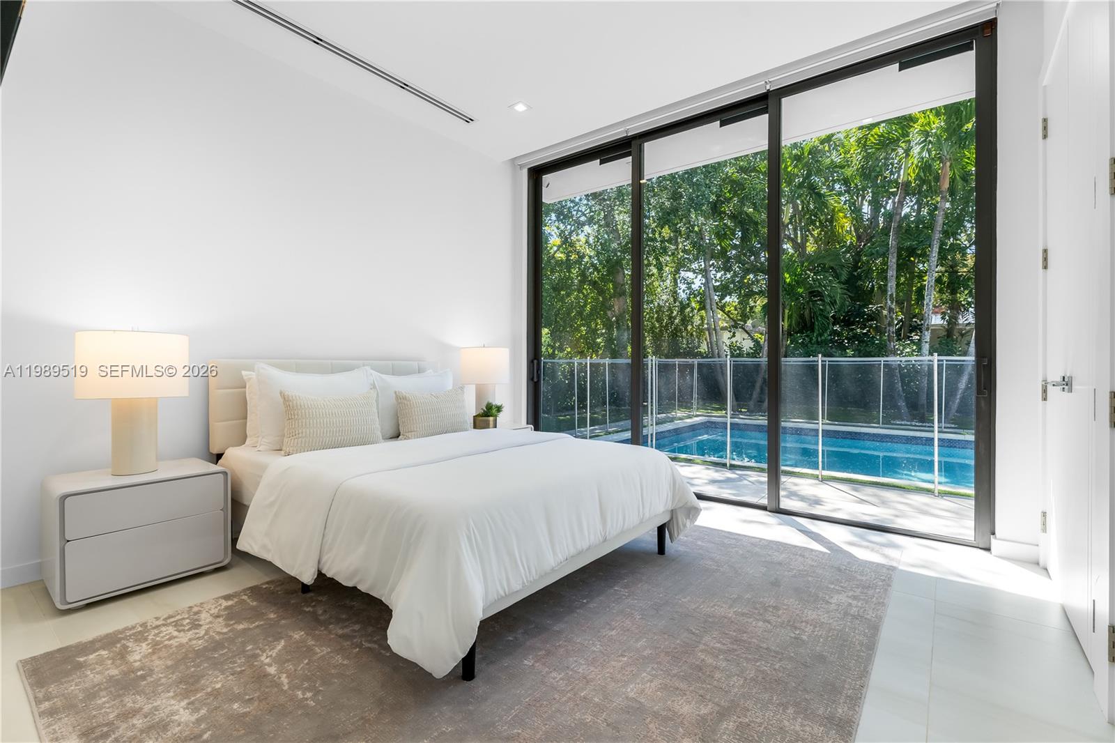 7900 Southwest 57th Court South Miami, FL 33143 - Photo 16 of 55 a bed room with a bed and a large window