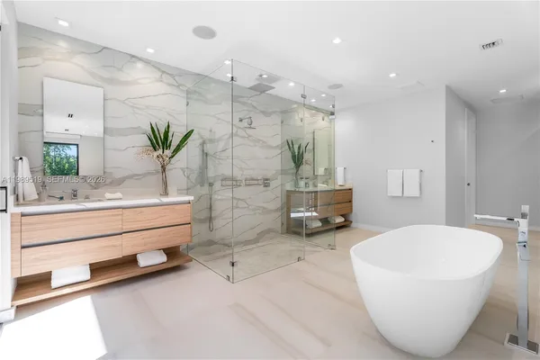 a bathroom with a large tub and shower
