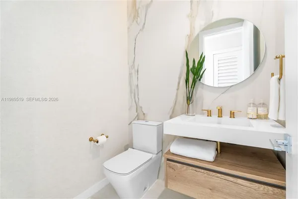 a white bath tub sitting next to a white toilet
