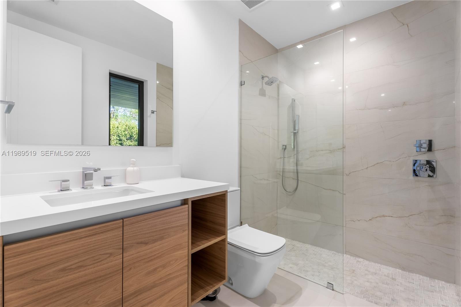 7900 Southwest 57th Court South Miami, FL 33143 - Photo 26 of 55 a bathroom with a sink a toilet and shower