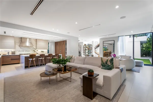 a living room with furniture garden view and a large window