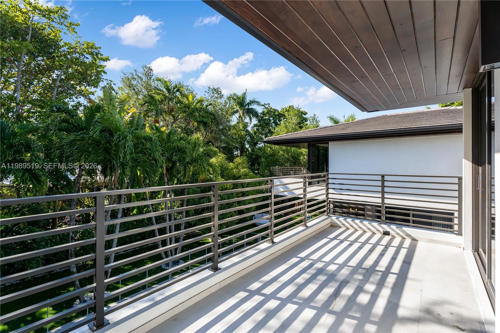 7900 Southwest 57th Court South Miami, FL 33143 - Photo 40 of 55 a view of a roof deck with wooden fence and stairs