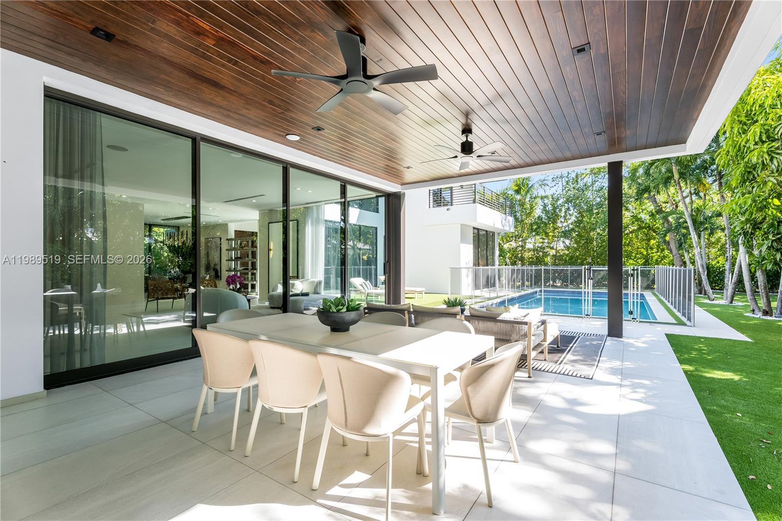 7900 Southwest 57th Court South Miami, FL 33143 - Photo 43 of 55 a view of a patio with a table chairs and a backyard