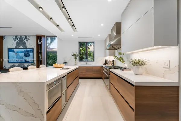 a bathroom with a sink a large mirror and a bathtub