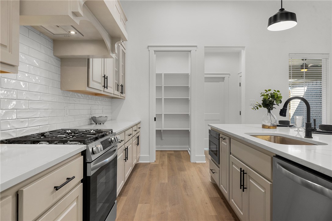 5020 Toscana Loop Bryan, TX 77802 - Photo 11 of 32 a kitchen with a sink stove and cabinets