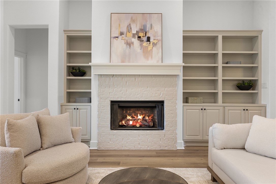 5020 Toscana Loop Bryan, TX 77802 - Photo 14 of 32 a living room with furniture a fireplace and a fireplace