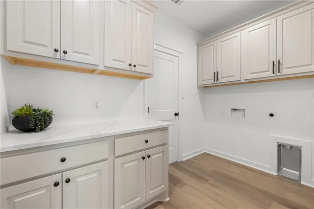 a kitchen with white cabinets and a sink