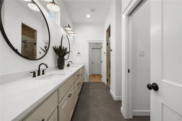 a bathroom with a sink a toilet and a mirror