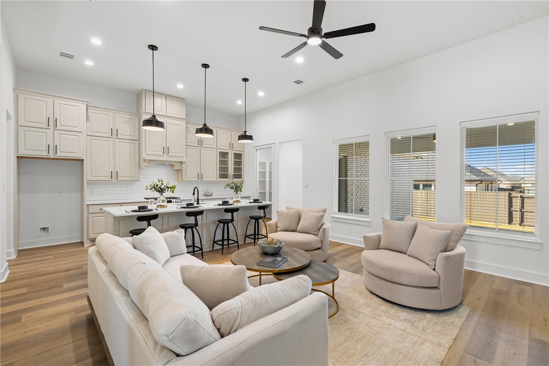 5020 Toscana Loop Bryan, TX 77802 - Photo 7 of 32 a living room with furniture kitchen view and a wooden floor