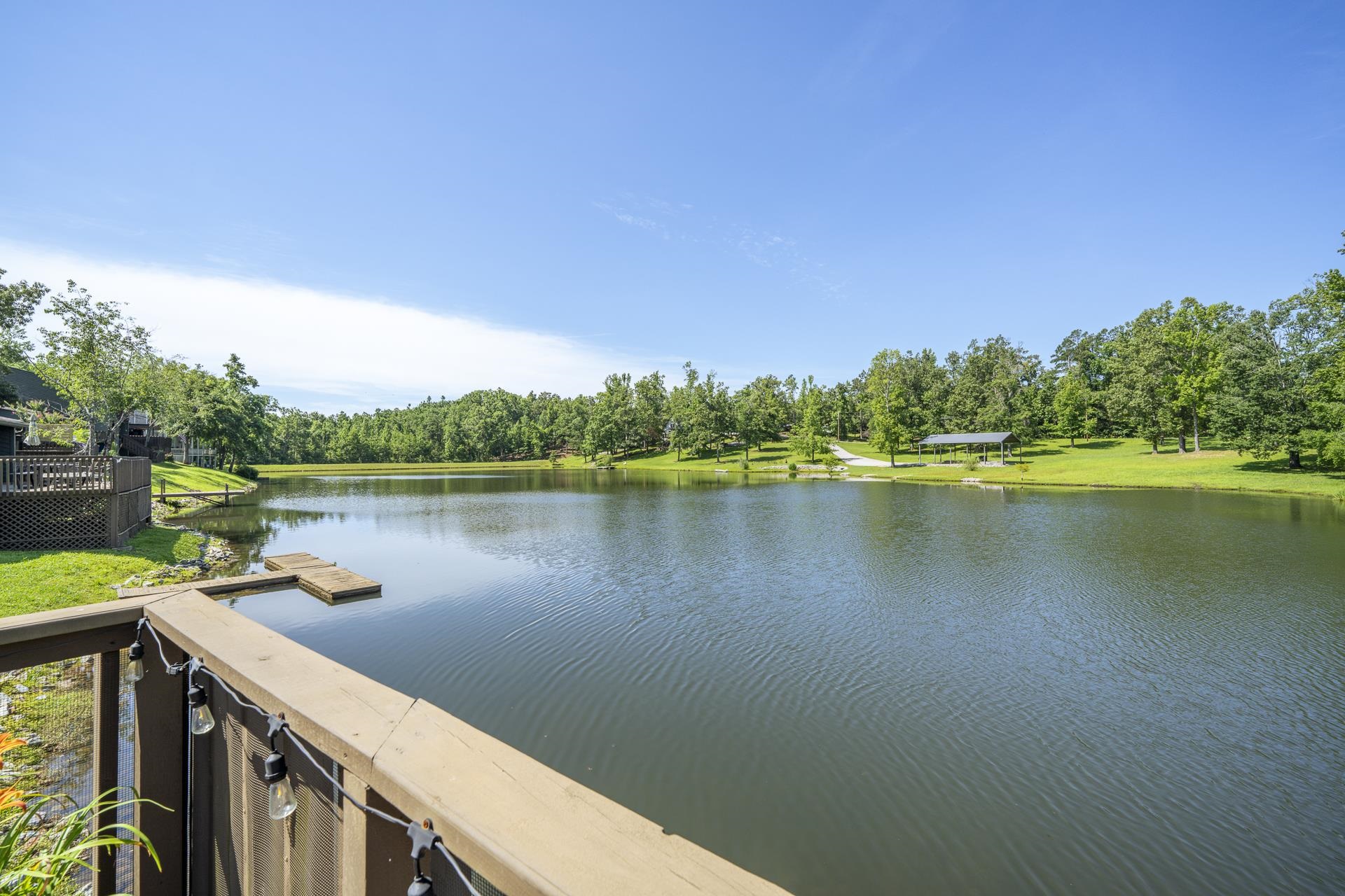 Lakeside property featuring a spacious deck with string lighting view is from the lower deck