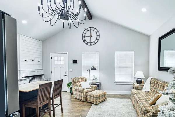 a living room with furniture a rug and a chandelier