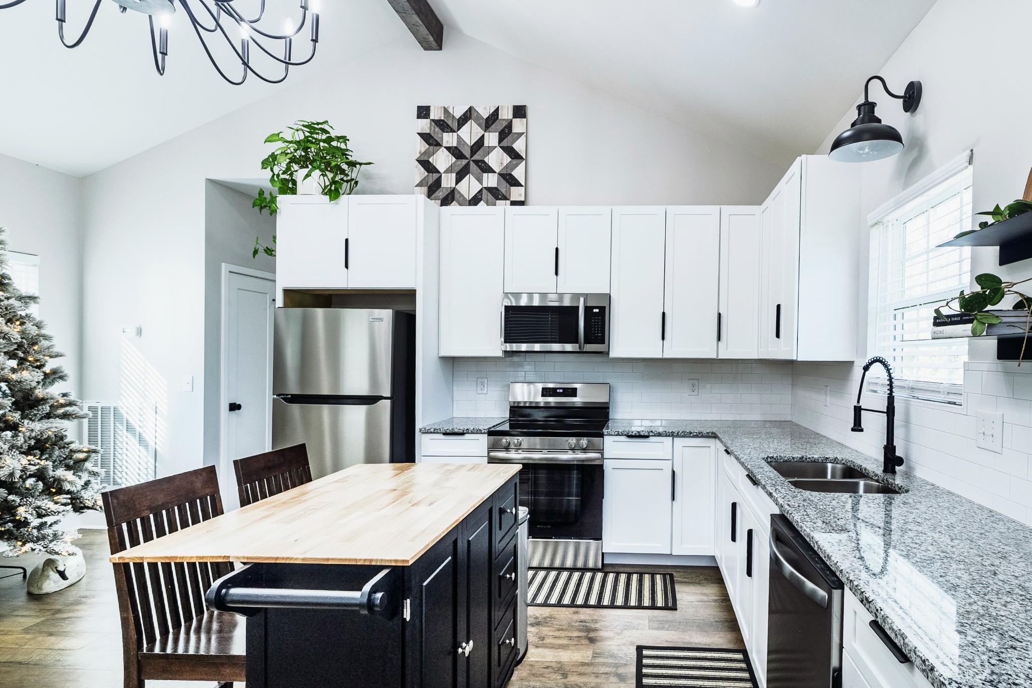 112 Wells Street Centerville, TN 37033 - Photo 6 of 22 a kitchen with granite countertop a white stove top oven a sink a dining table and chairs
