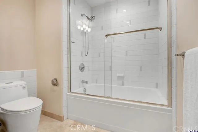 a bathroom with a shower and a toilet