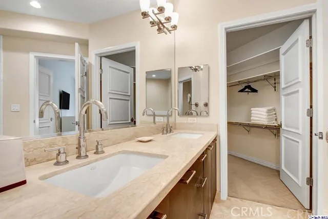 a bathroom with a granite countertop sink a large mirror and a shower