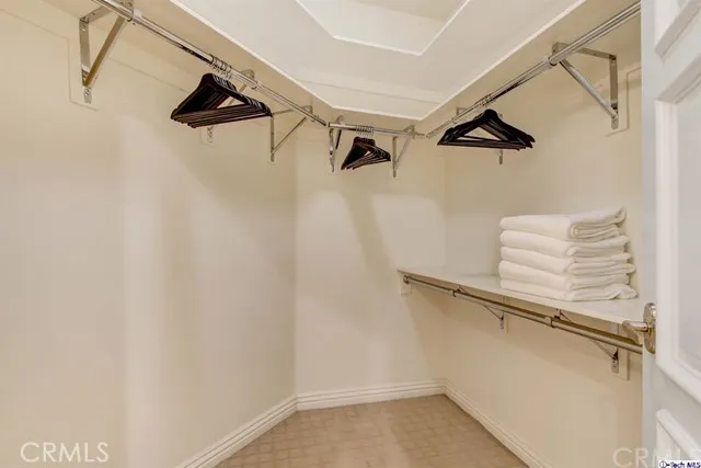 a view of walk in closet with empty racks