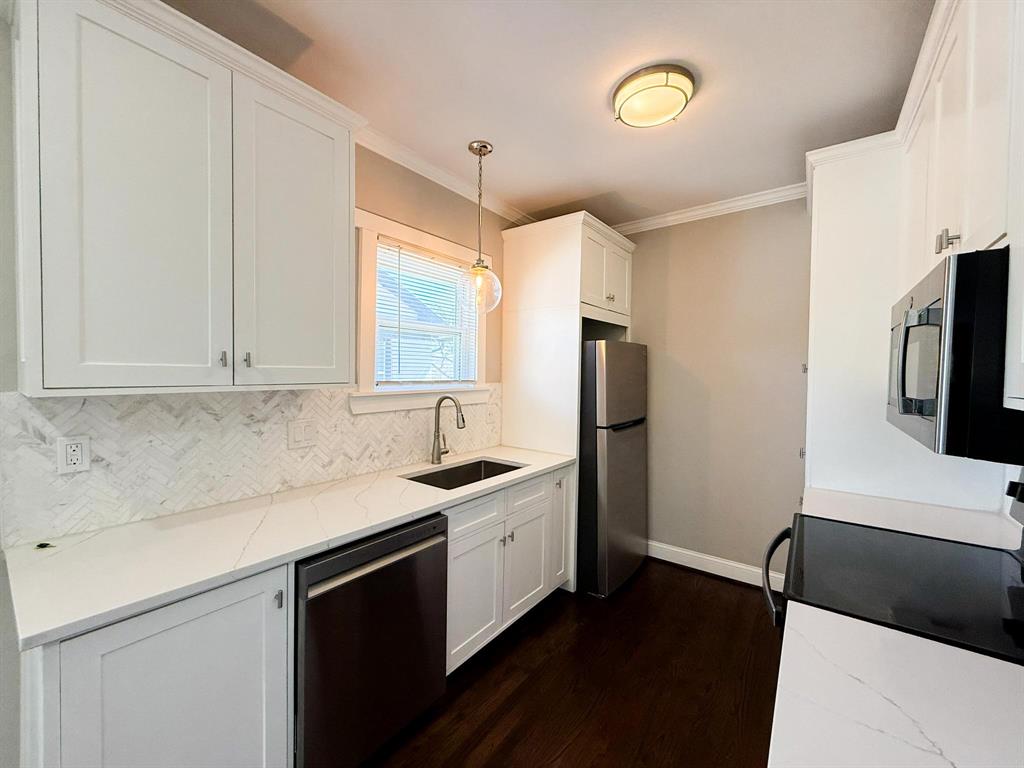 4114 Junius Street, Unit B Dallas, TX 75246 - Photo 12 of 23 a kitchen with appliances cabinets and a sink